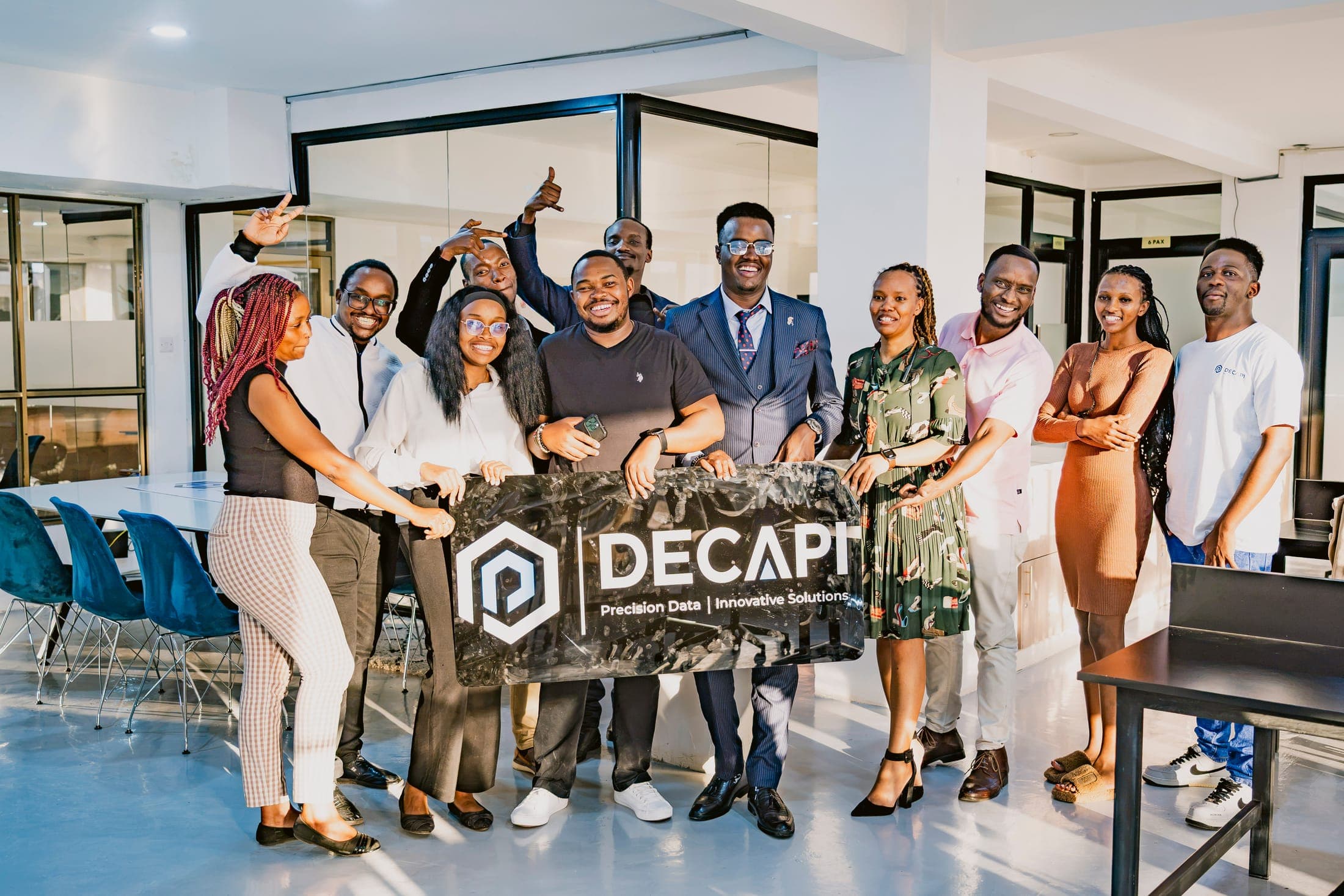 The DECAPI team with the company banner